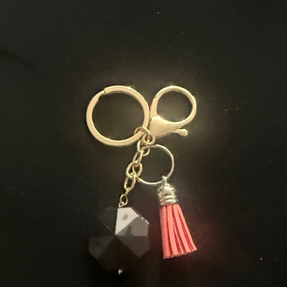 Elegant Gold and Black Keychain with Pink Tassel